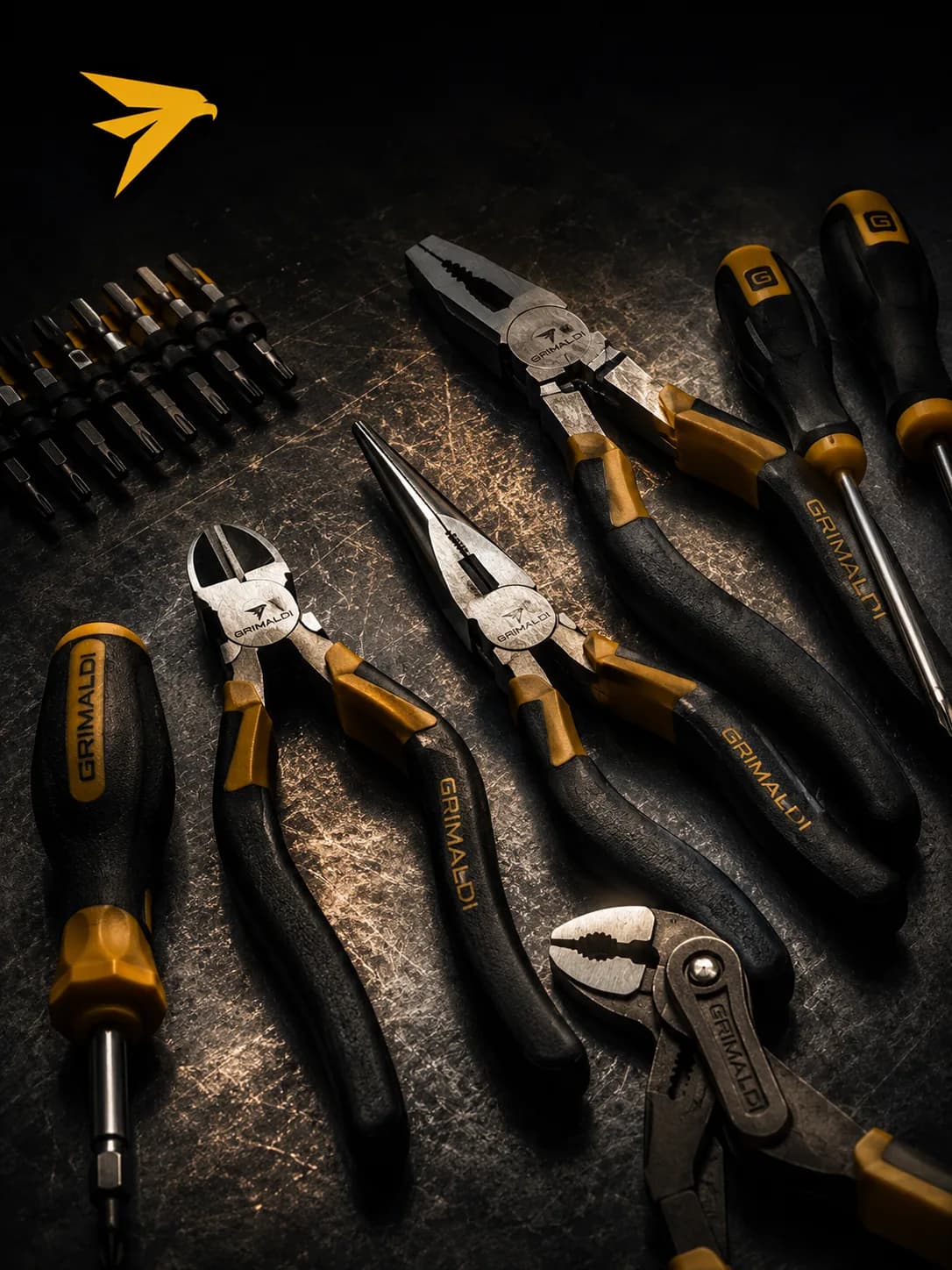 Grimaldi pliers, screwdrivers and driver bits laid out on a steel workbench