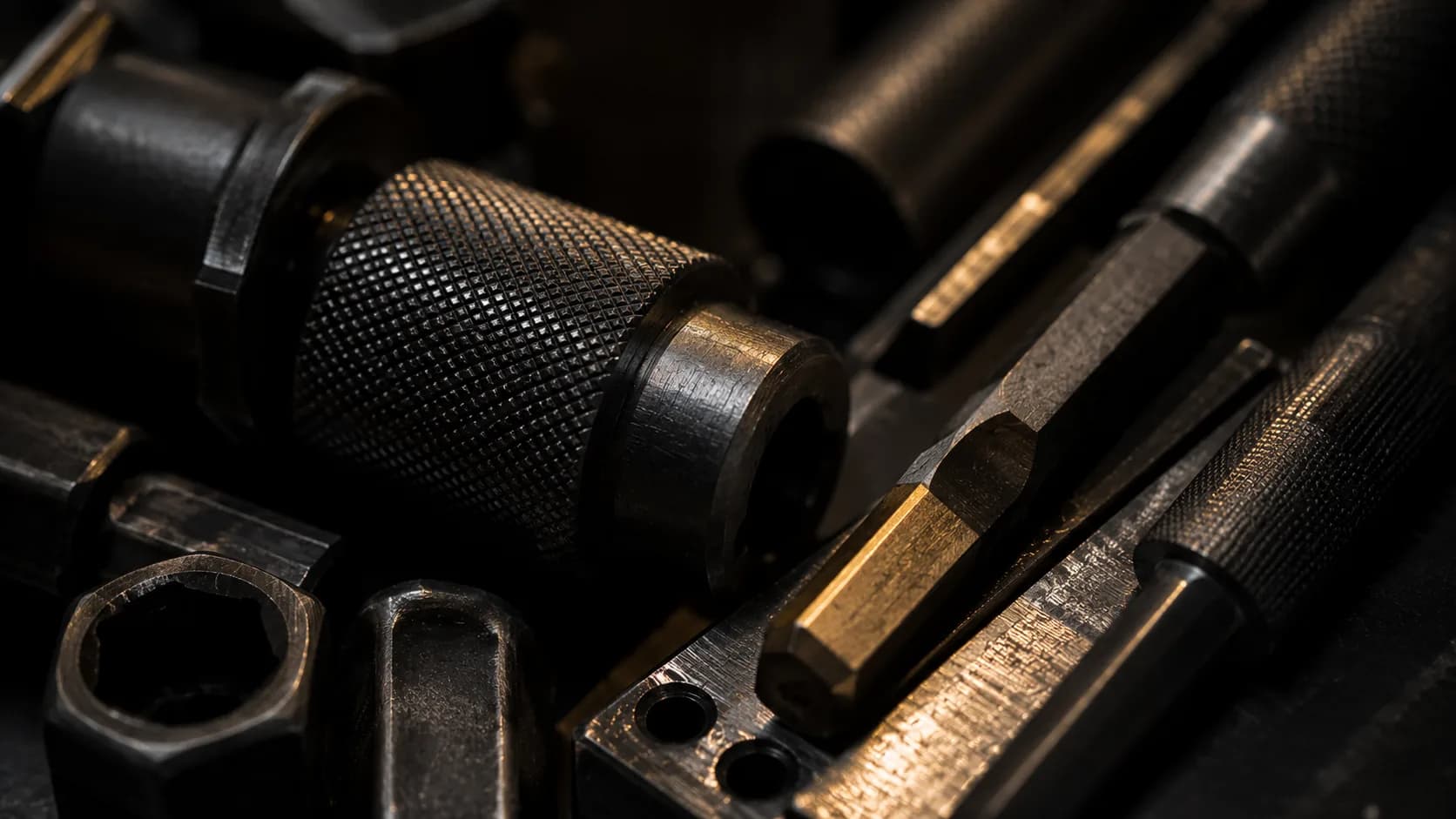 Close up of knurled steel tool fittings and hex driver bits